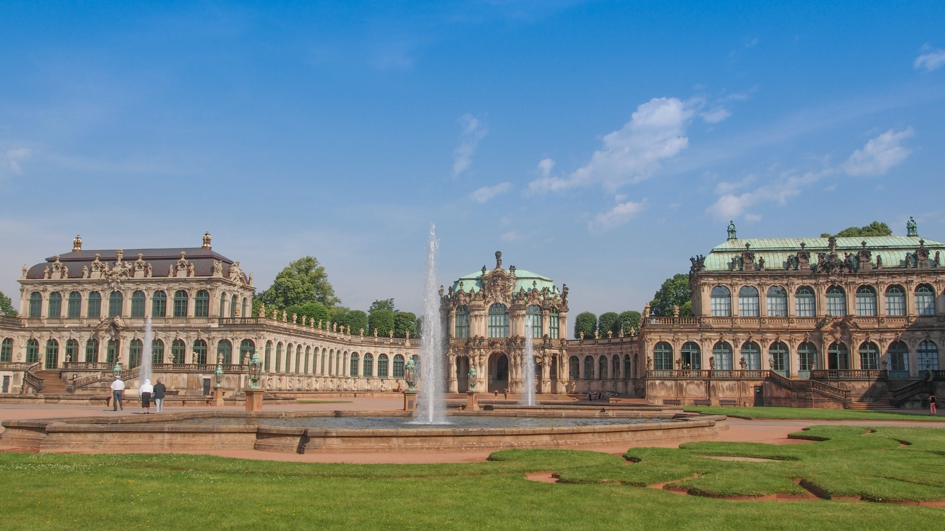 Garten mit einem Springbrunnen und einem Schloss im Hintergrund