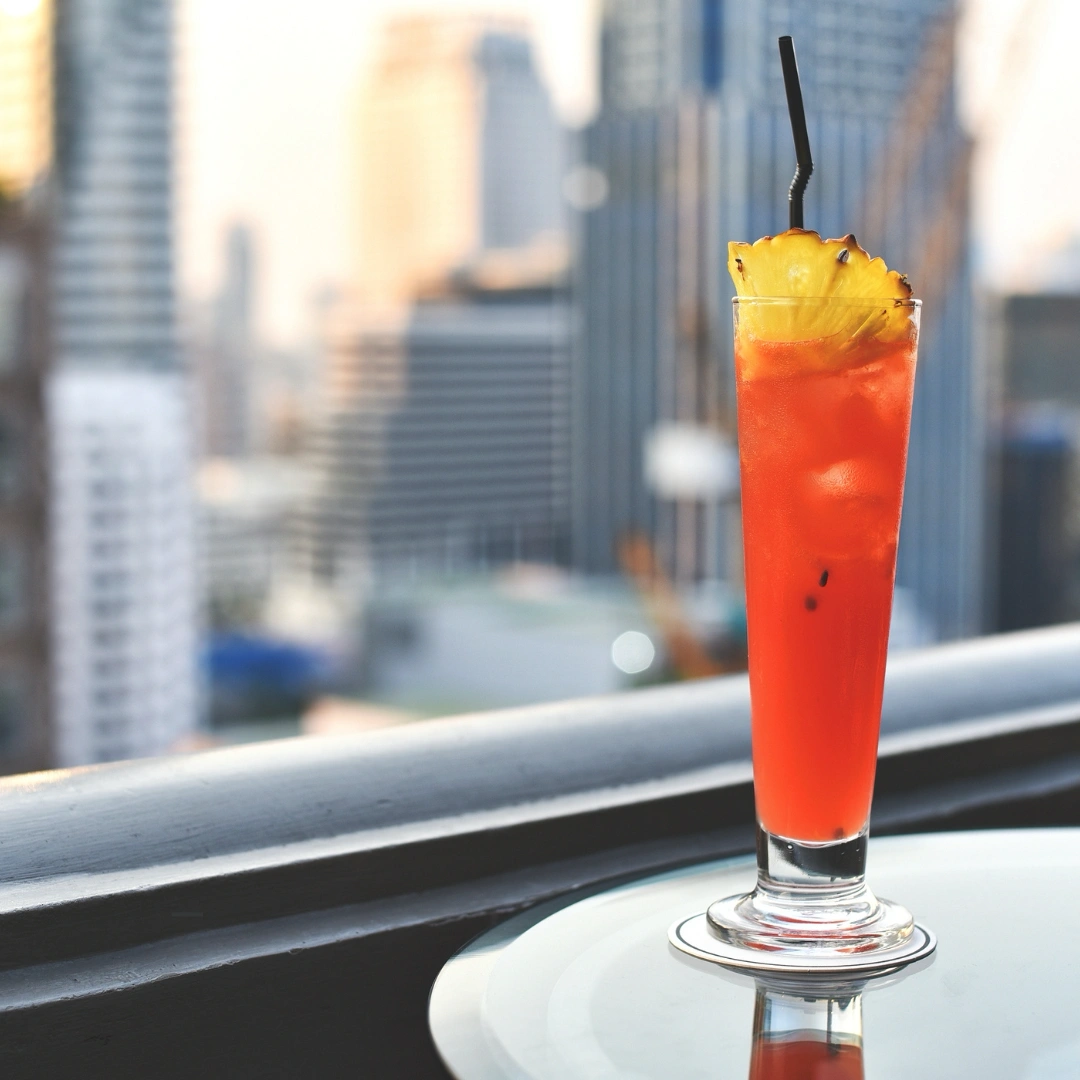 A orange Cocktail infant of a city skyline