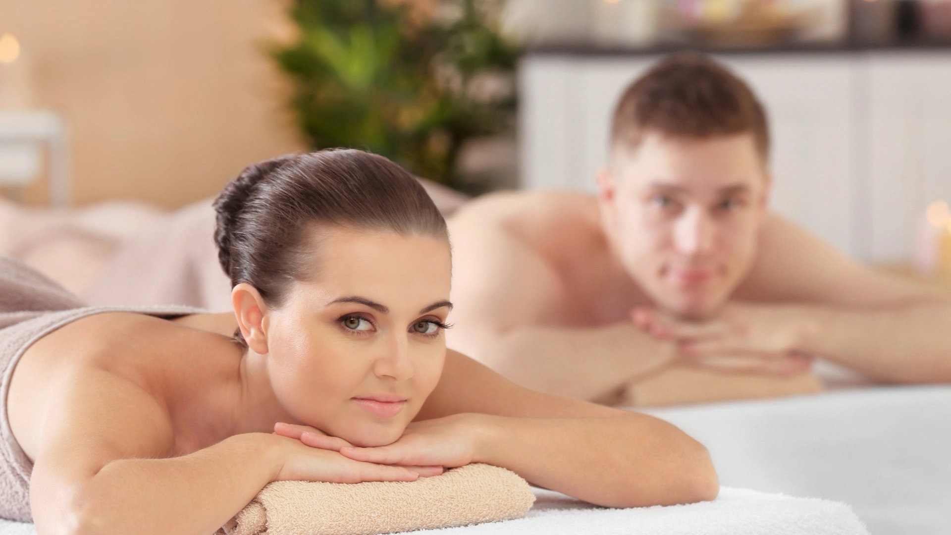 Ma and woman laying on their belly in a spa