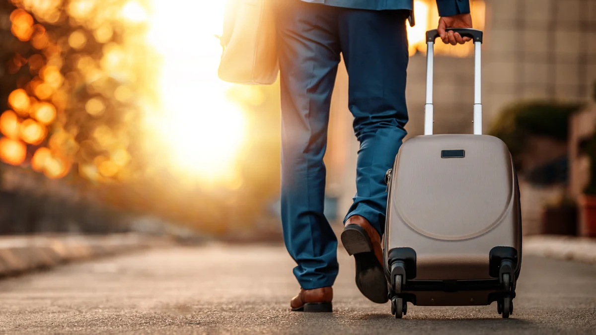 Man walking with a trolley to the sunset