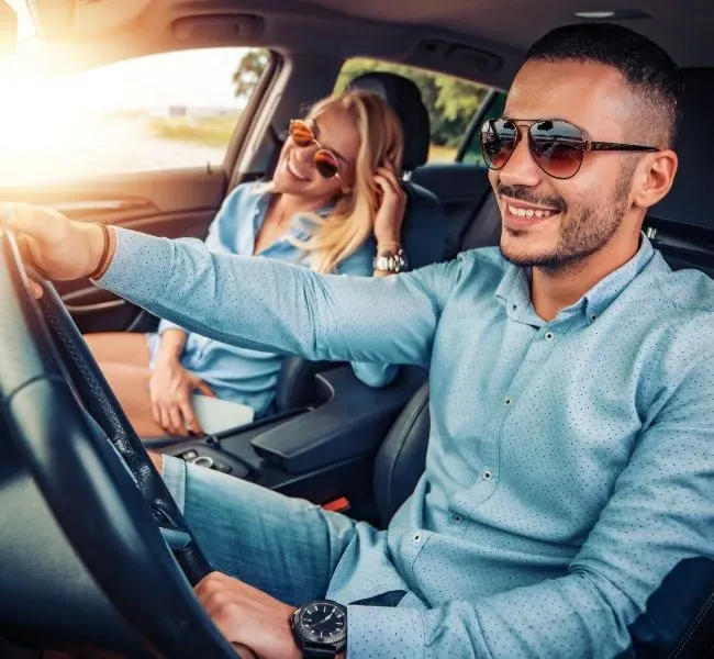 An escort lady being driven to the date by a friend